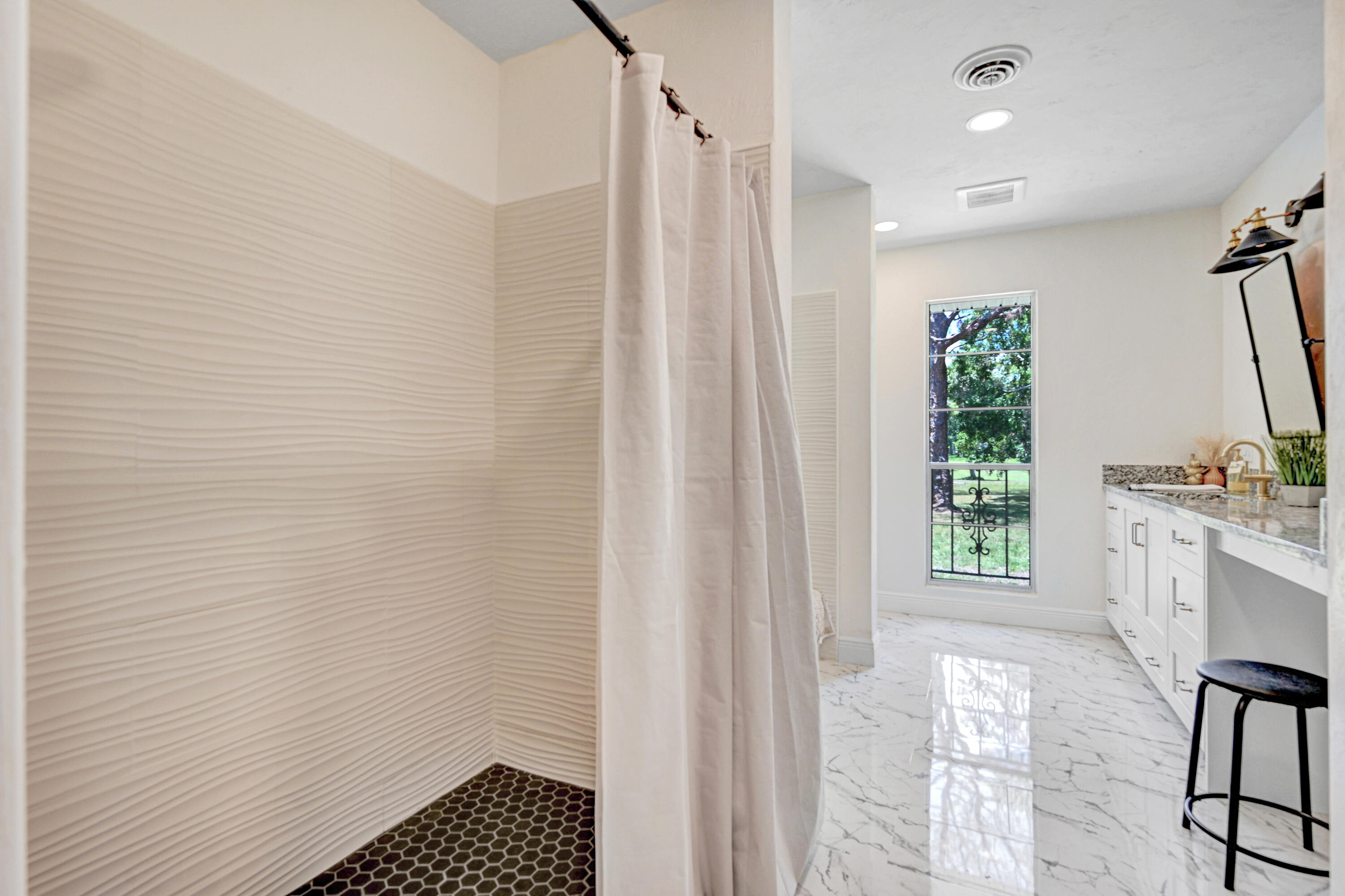 2340 Turtle Mound Road Melbourne, FL 32934 - Photo 17 of 30 a bathroom with a sink a mirror and a shower