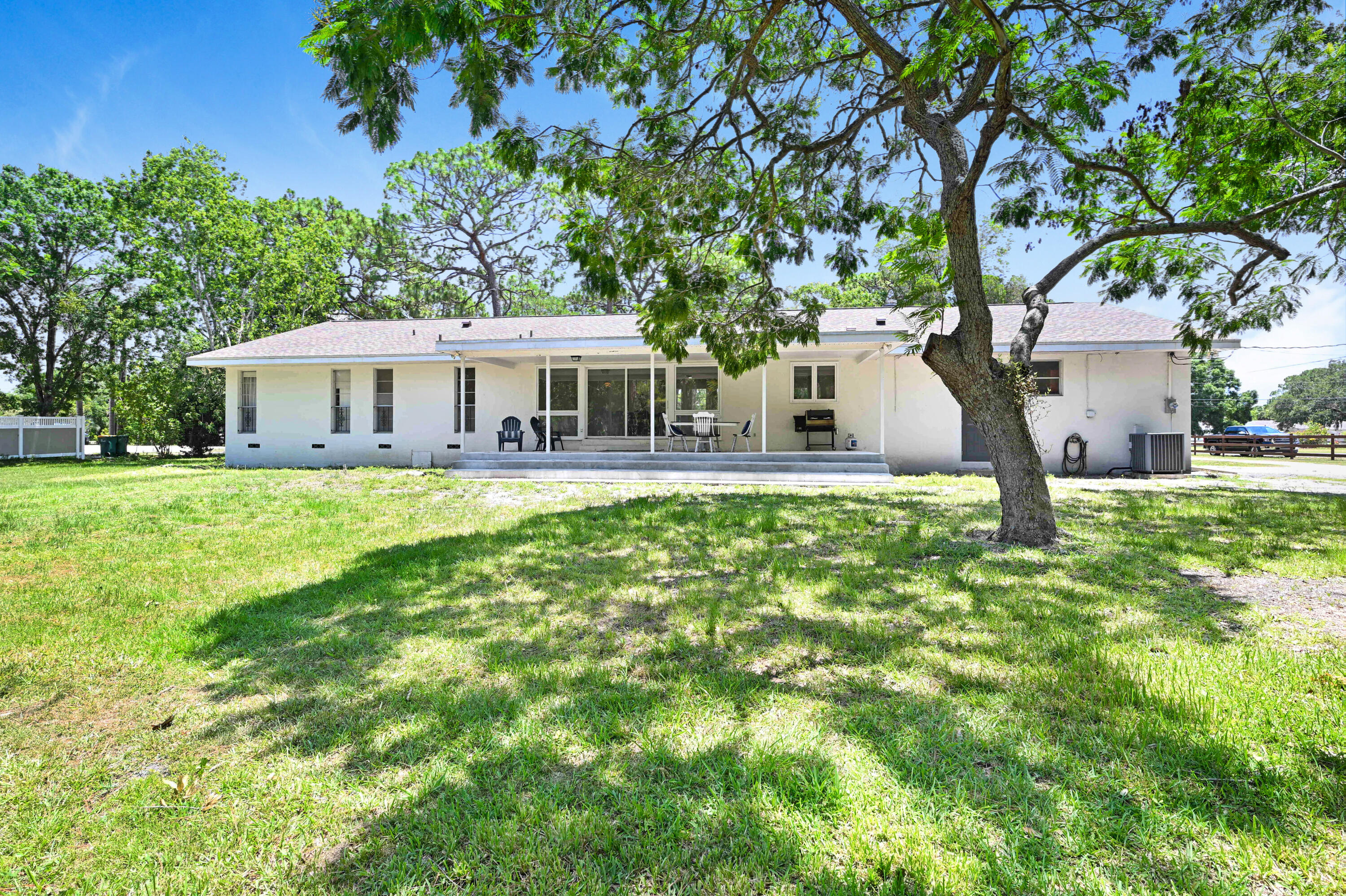 2340 Turtle Mound Road Melbourne, FL 32934 - Photo 24 of 30 a front view of a house with a yard table and chairs