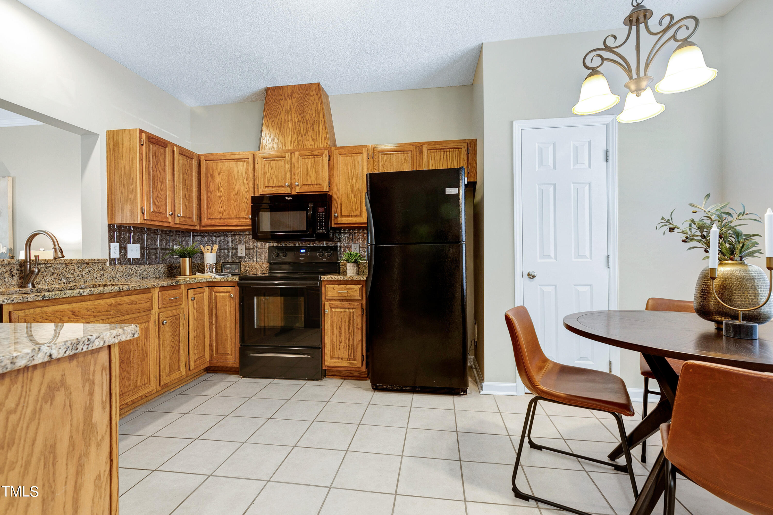 4414 Still Pines Drive Raleigh, NC 27613 - Photo 8 of 36 a kitchen with a sink cabinets and refrigerator