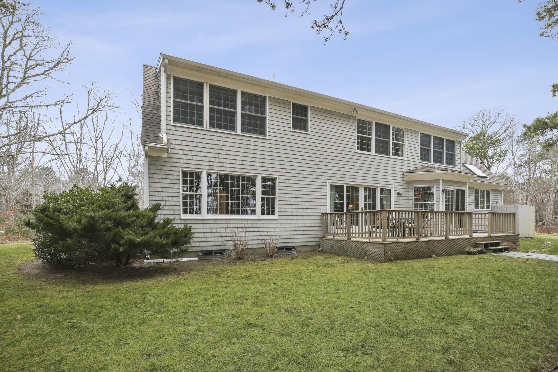 8 Clark's Point Road Eastham, MA 02642 - Photo 27 of 35 a front view of a house with a yard and potted plants