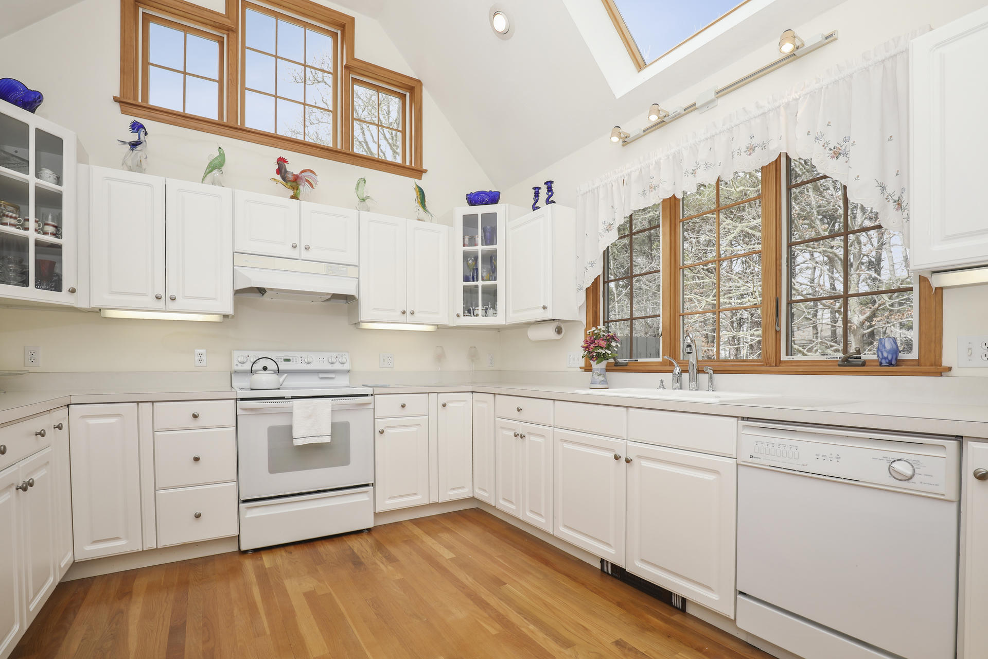 8 Clark's Point Road Eastham, MA 02642 - Photo 10 of 35 a kitchen with granite countertop white cabinets and white appliances