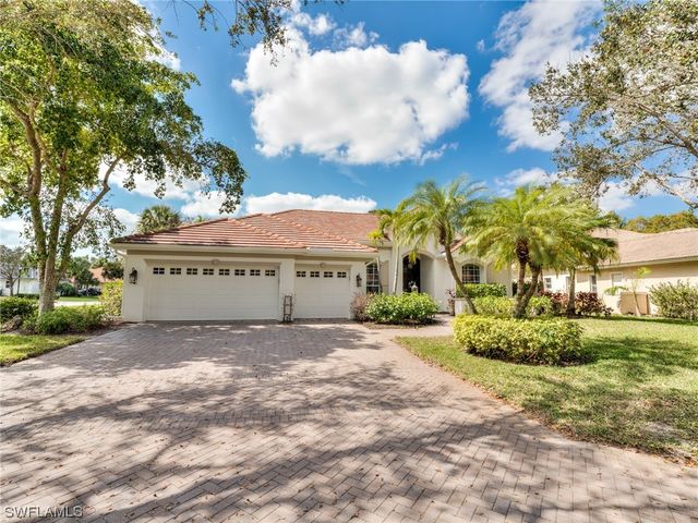 a view of a white house with a yard and fence