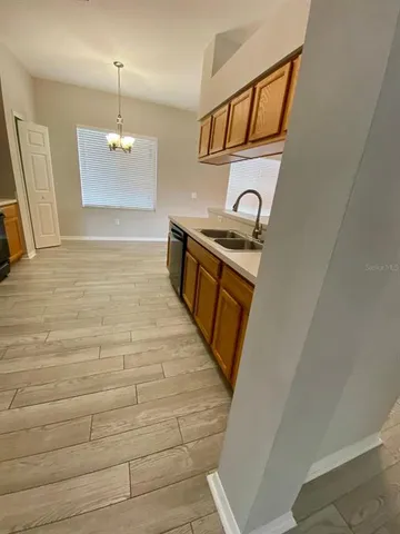 a spacious bathroom with a granite countertop sink and a mirror