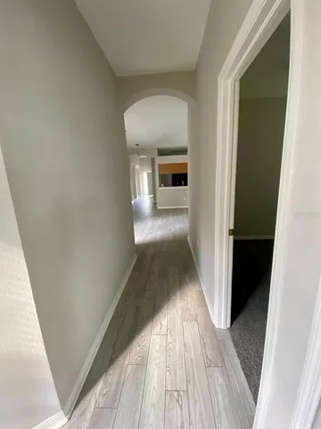 a view of a hallway view with wooden floor and staircase