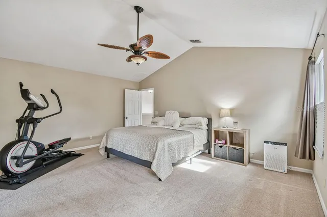 a bedroom with a bed a desk and chair