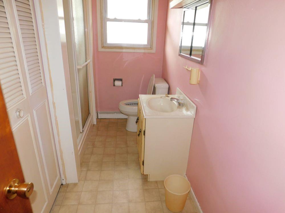 443 Fairview Road Fredonia, PA 16124 - Photo 3 of 12 a bathroom with a sink toilet and window