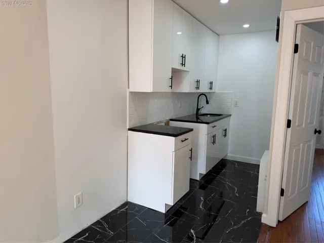 a kitchen with a sink and cabinets