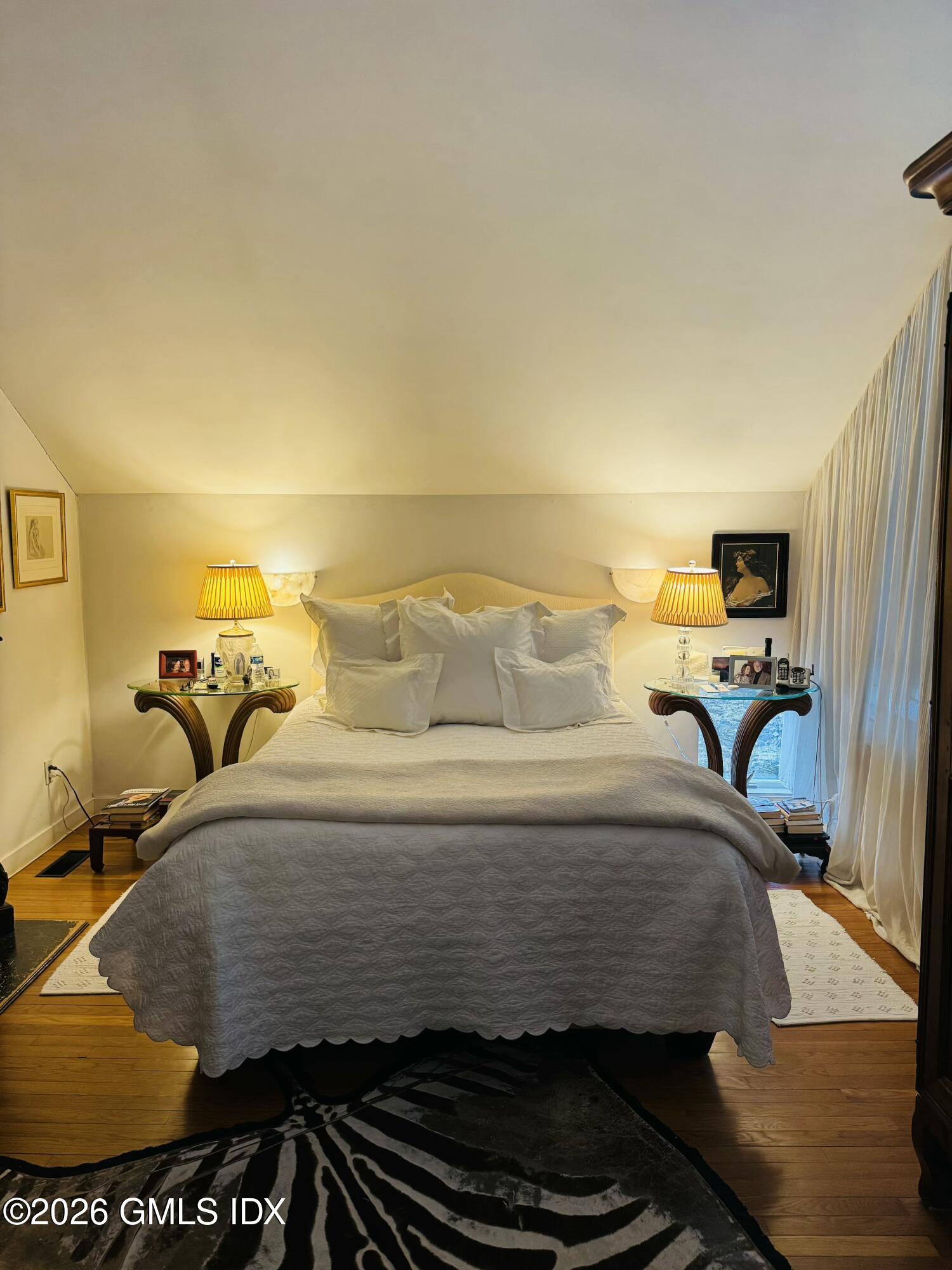 332 Riversville Road Greenwich, CT 06831 - Photo 17 of 22 a bedroom with a bed and wooden floor