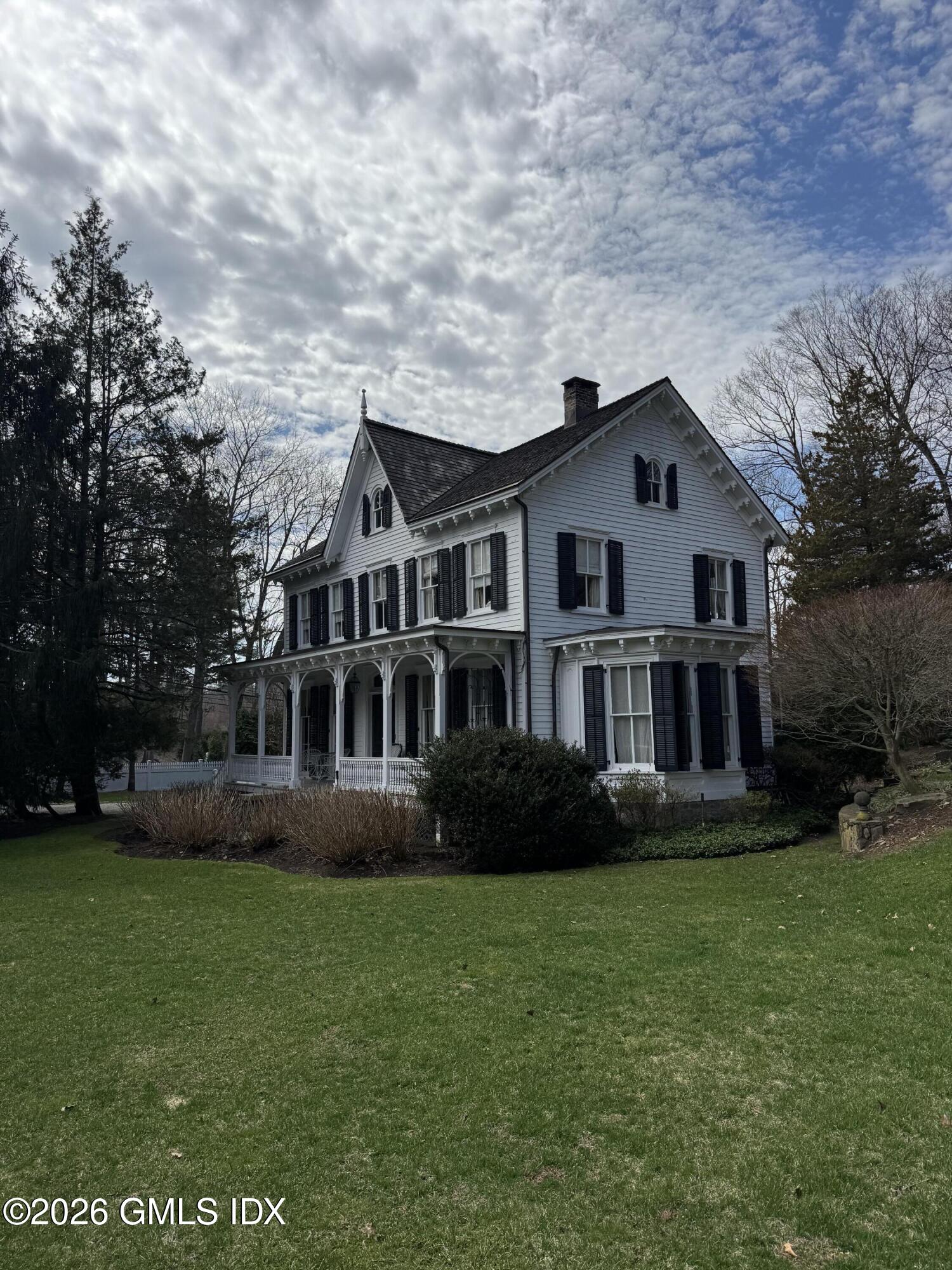 332 Riversville Road Greenwich, CT 06831 - Photo 2 of 22 a front view of a house with garden and trees