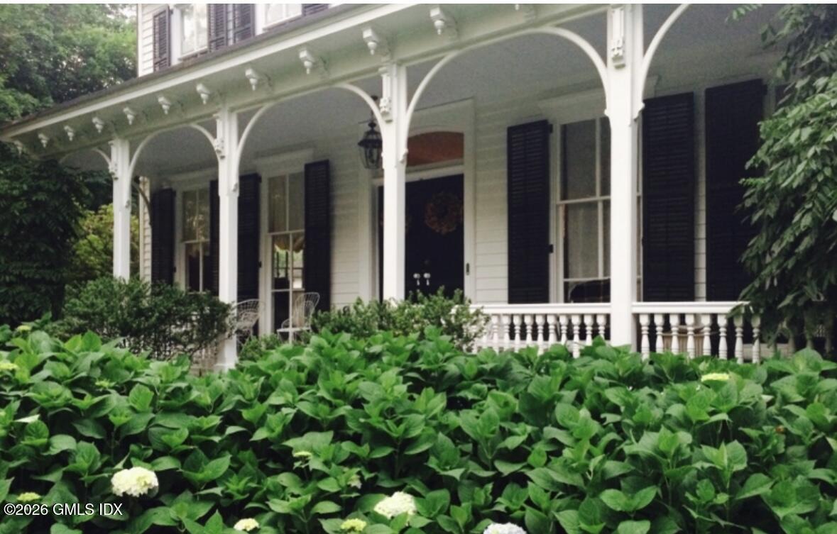 332 Riversville Road Greenwich, CT 06831 - Photo 21 of 22 a view of a house with large windows and flower plants