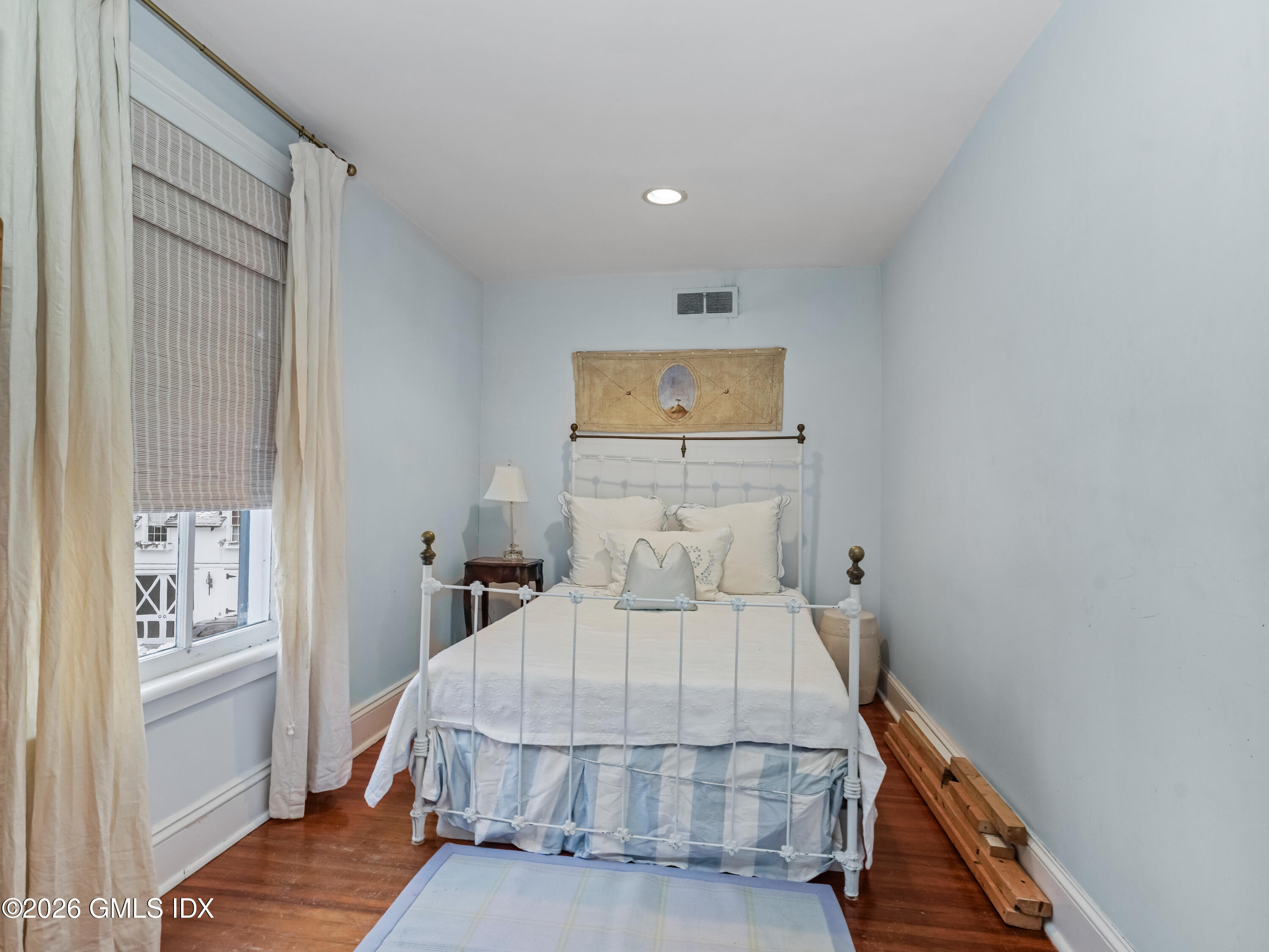332 Riversville Road Greenwich, CT 06831 - Photo 9 of 22 a bedroom with a bed and wooden floor