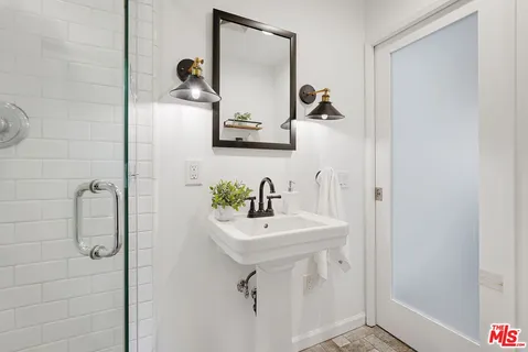 a bathroom with a sink and mirror