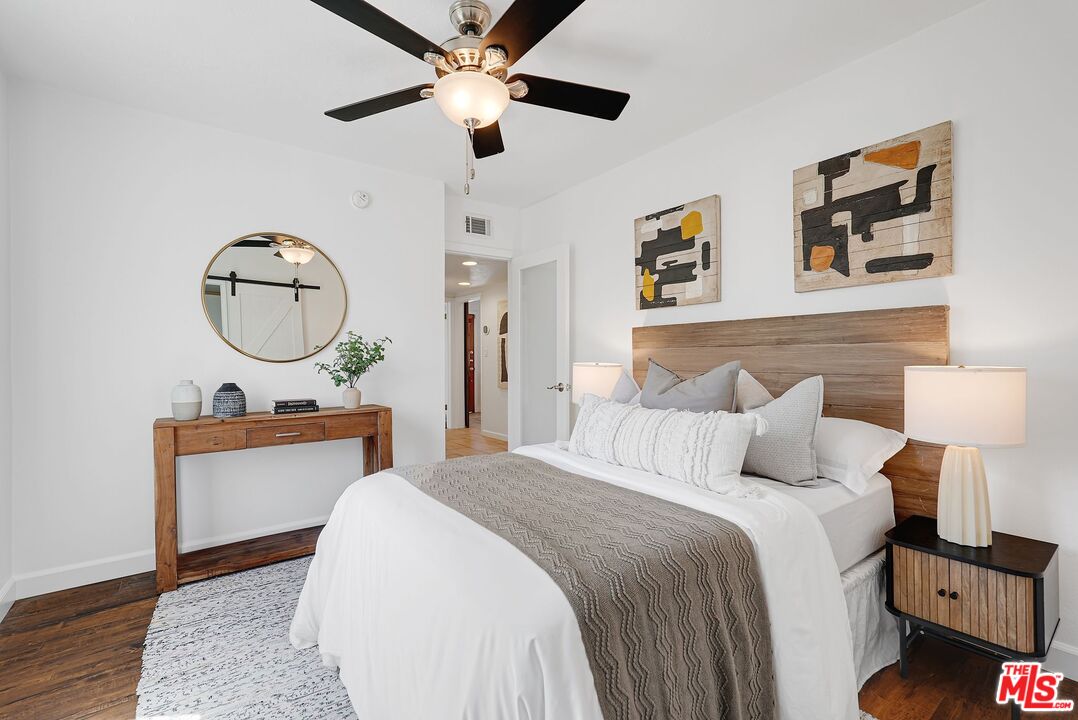 5350 Fallbrook Avenue Woodland Hills, CA 91367 - Photo 14 of 25 a bedroom with a bed and a chandelier