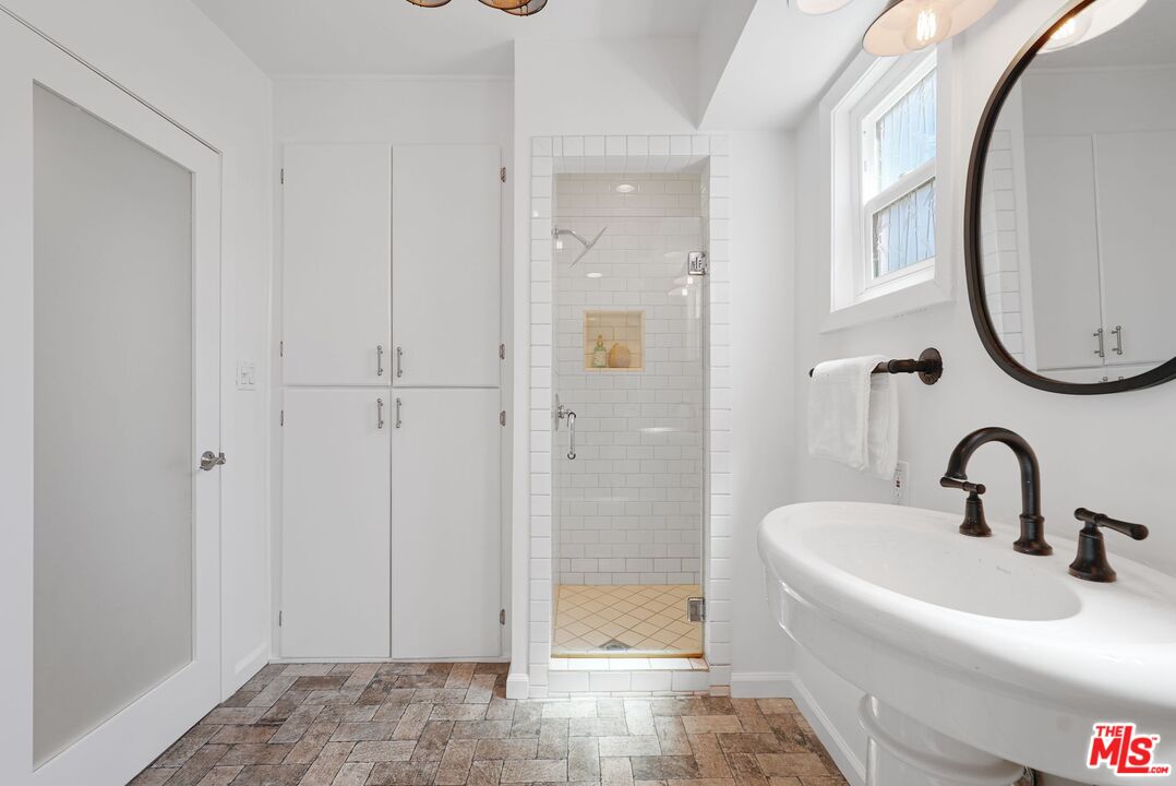 5350 Fallbrook Avenue Woodland Hills, CA 91367 - Photo 17 of 25 a bathroom with a sink and a mirror