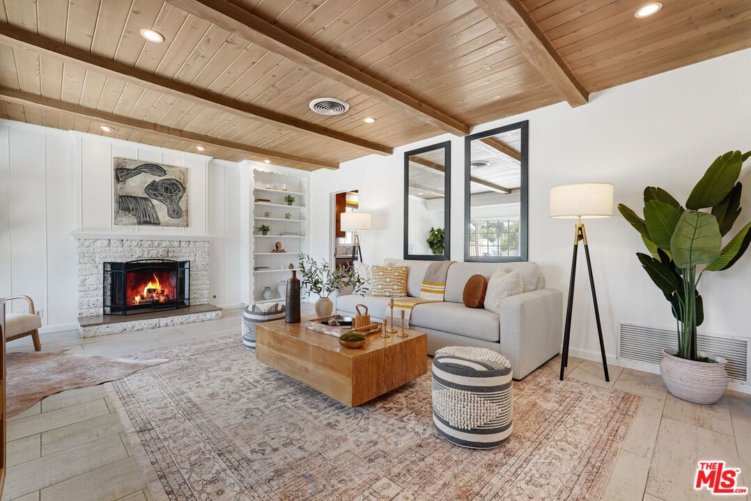 5350 Fallbrook Avenue Woodland Hills, CA 91367 - Photo 2 of 25 a living room with furniture a large window and a fireplace