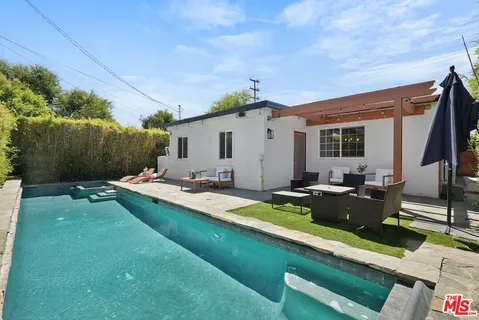 a view of swimming pool with outdoor seating and plants