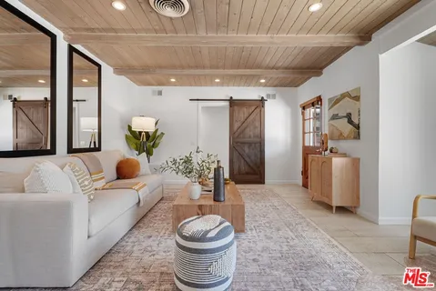 a living room with furniture and a rug