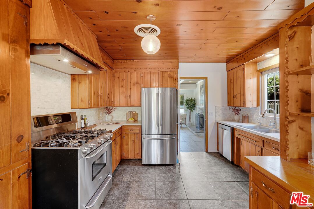 5350 Fallbrook Avenue Woodland Hills, CA 91367 - Photo 5 of 25 a kitchen with stainless steel appliances granite countertop a stove refrigerator and cabinets