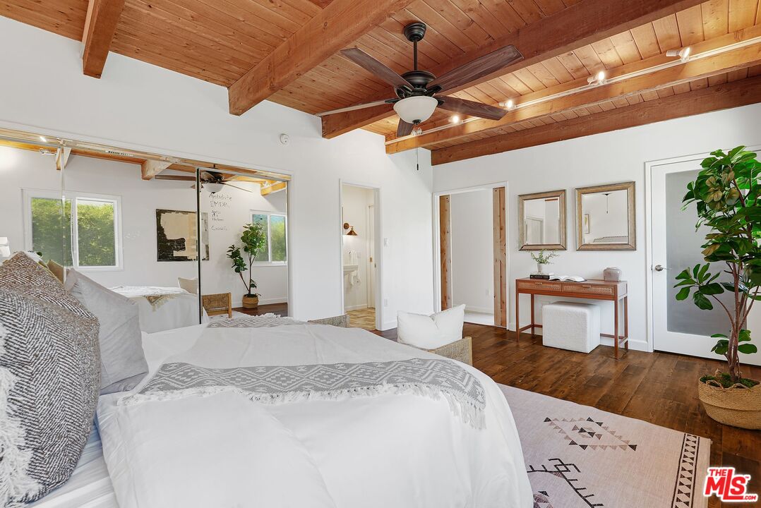 5350 Fallbrook Avenue Woodland Hills, CA 91367 - Photo 10 of 25 a bedroom with a bed a chandelier and flat screen tv