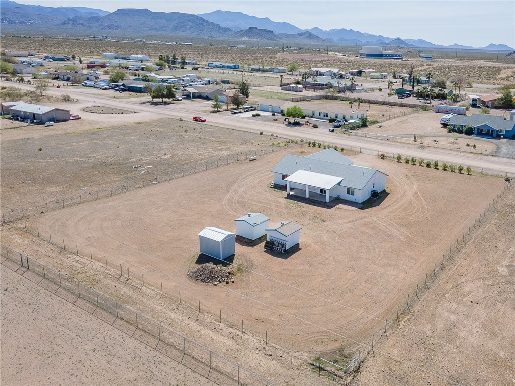 3411 West Carmichael Road Golden Valley, AZ 86413 - Photo 94 of 97 Aerial view of sparsely populated area with nearby suburban area and a mountainous background