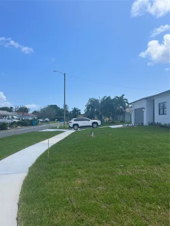 a view of a house with a yard and a swimming pool