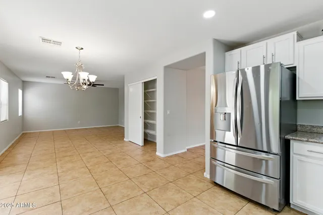 a kitchen with kitchen island and stainless steel appliances