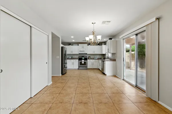 a view of a kitchen with a sink and a refrigerator