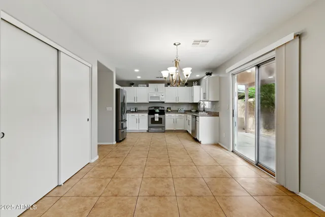 a view of a kitchen with a sink and a refrigerator