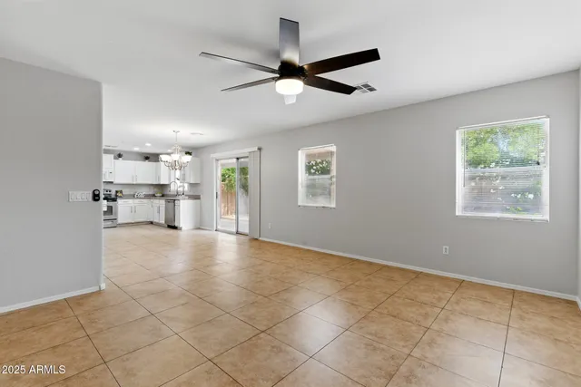 a view of a livingroom with a ceiling fan and window