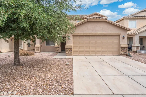 a small white house with outdoor space