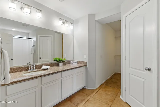 a bathroom with double sink and a mirror