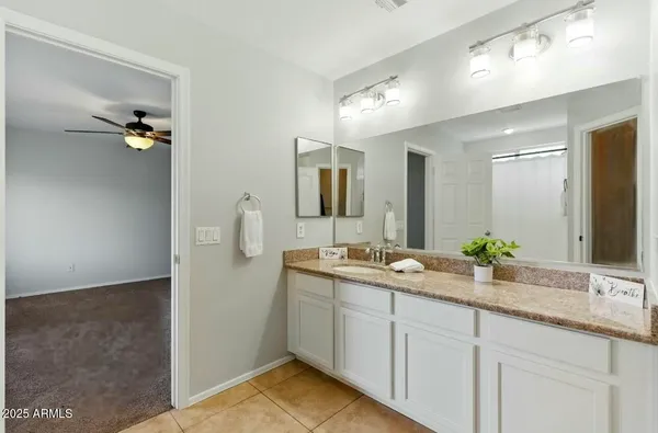 a bathroom with a double vanity sink and mirror