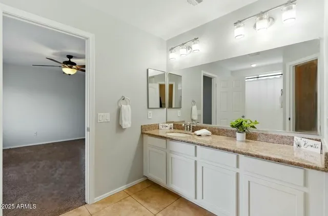a bathroom with a double vanity sink and mirror