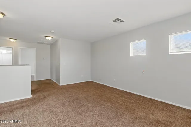 a view of an empty room with a kitchen