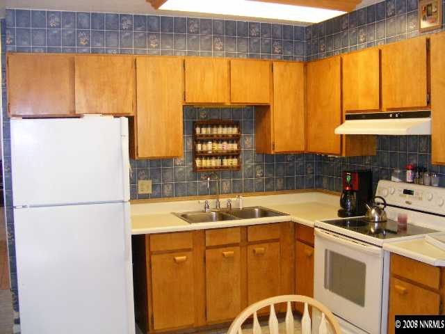 1270 Rayburn Drive Reno, NV 89503 - Photo 4 of 9 a kitchen with a window a sink and a refrigerator