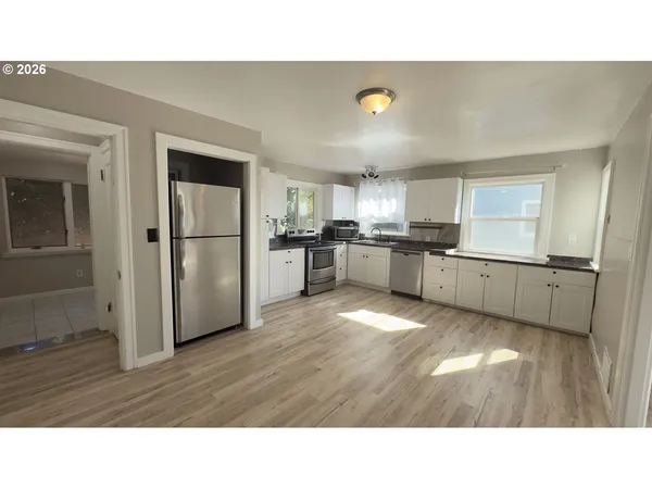 a kitchen with a sink and a mirror