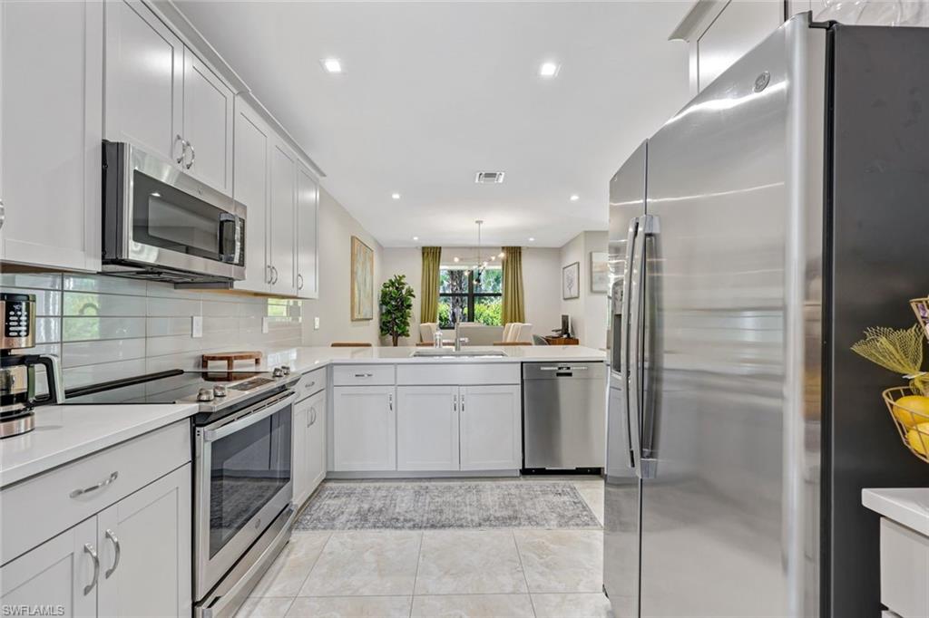 7348 Rockefeller Drive Naples, FL 34119 - Photo 8 of 39 Kitchen - Featuring Stainless Steel Appliances & Quartz Countertops