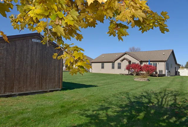 a view of a house with a backyard