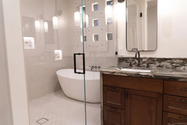 a bathroom with a double vanity sink a mirror and a shower