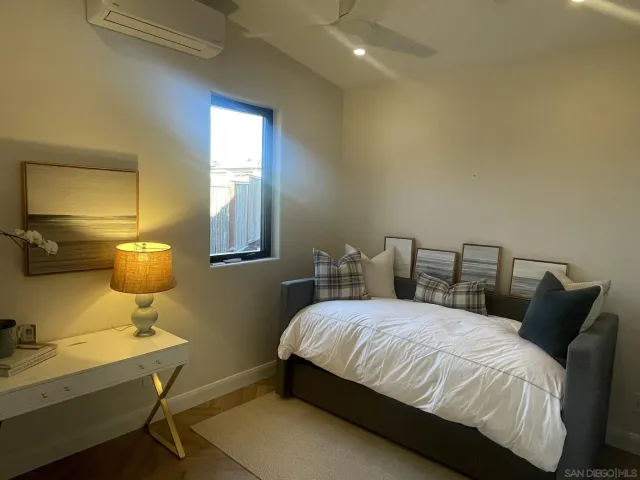 a bedroom with a bed and window