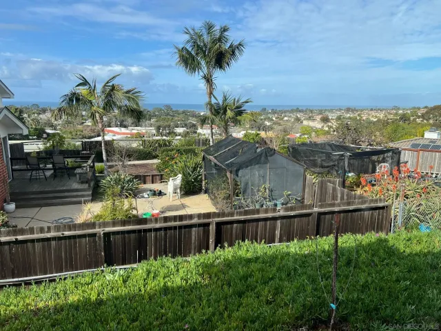 a view of a houses with a lake from a balcony