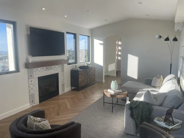 a living room with furniture and a fireplace