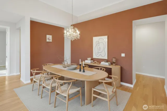 a kitchen with a sink a refrigerator and wooden floor