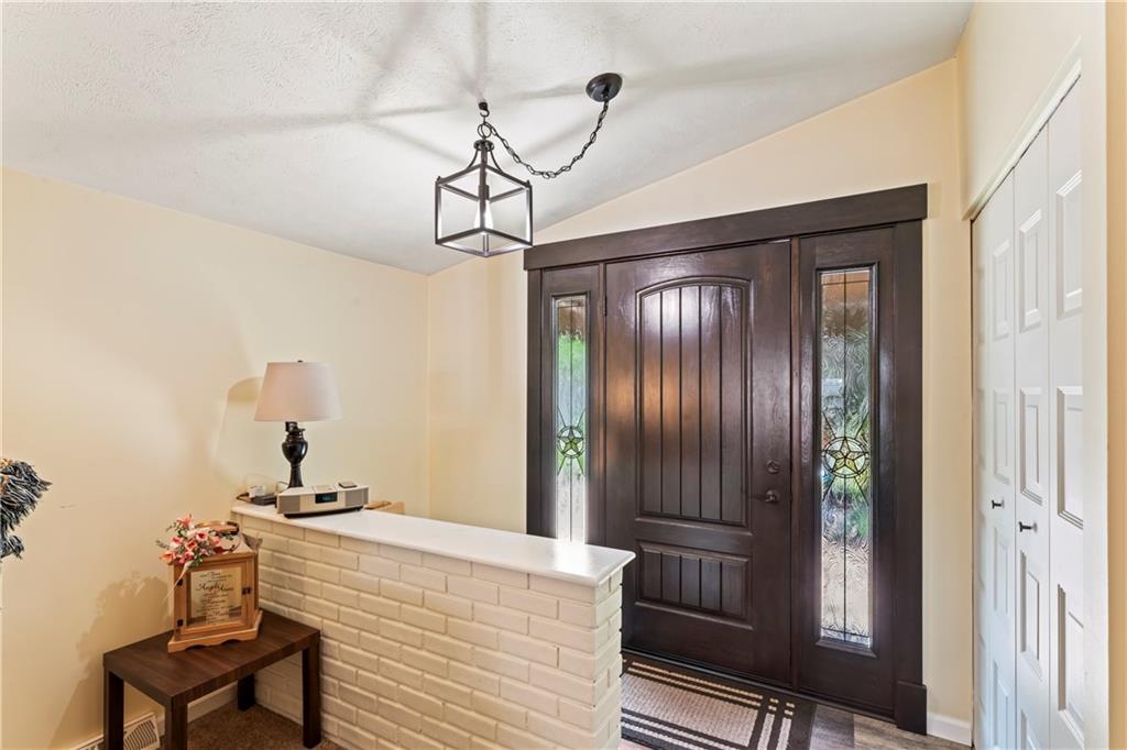 19 Ellen Drive McKees Rocks, PA 15136 - Photo 2 of 38 a bedroom with a bed and a chandelier