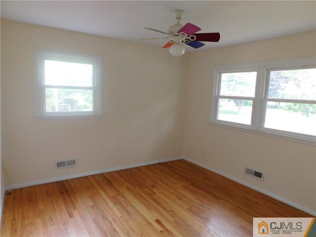 1 Perry Road East Brunswick, NJ 08816 - Photo 12 of 18 a view of a room with wooden floor and a window