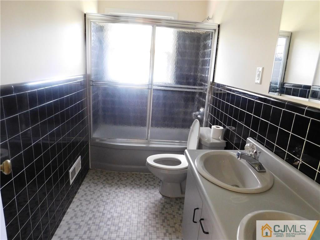 1 Perry Road East Brunswick, NJ 08816 - Photo 15 of 18 a bathroom with a sink toilet and shower