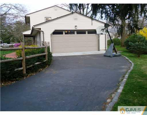 1 Perry Road East Brunswick, NJ 08816 - Photo 4 of 18 a view of a white house with a yard