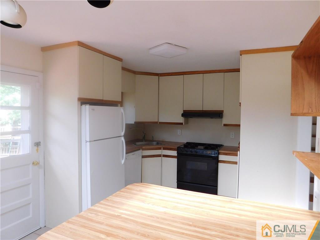 1 Perry Road East Brunswick, NJ 08816 - Photo 10 of 18 a kitchen with a sink and a refrigerator