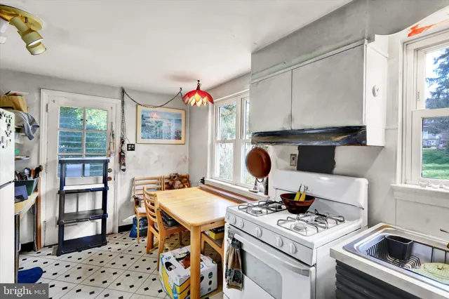 a kitchen with a appliances a stove a table and chair