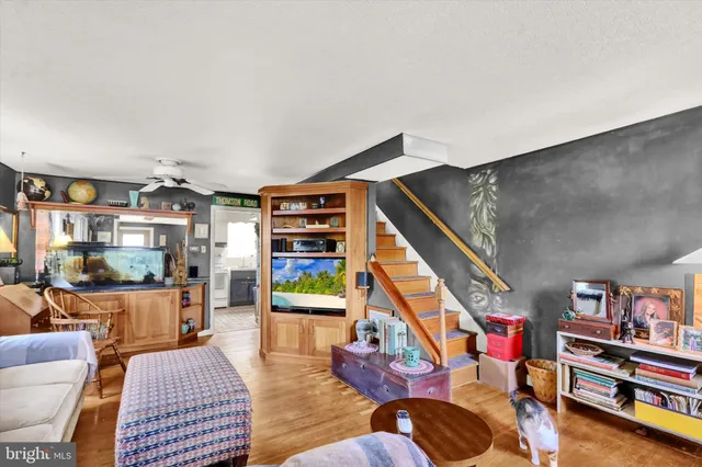 a living room with furniture and a book shelf
